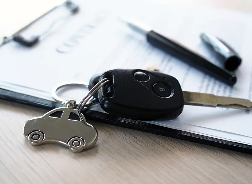Car key with contract on desk