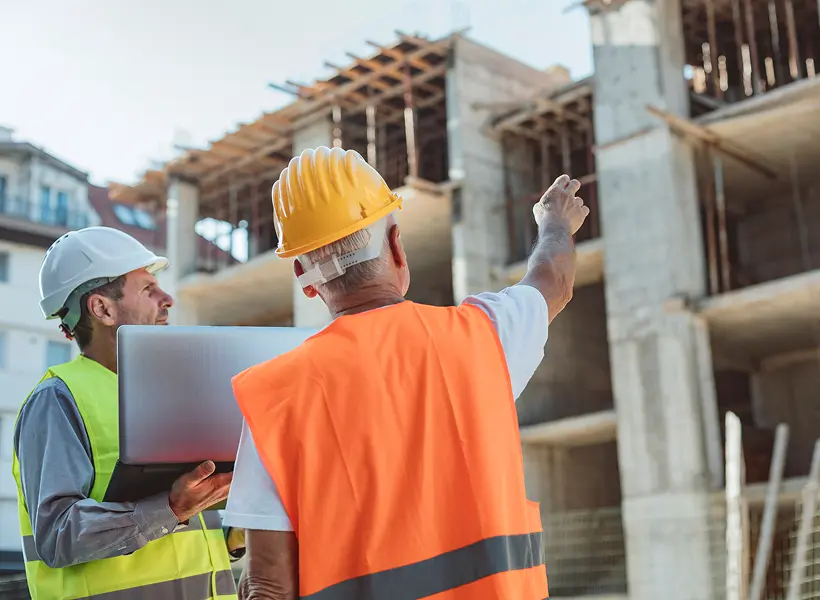 Construction workers discussing building progress