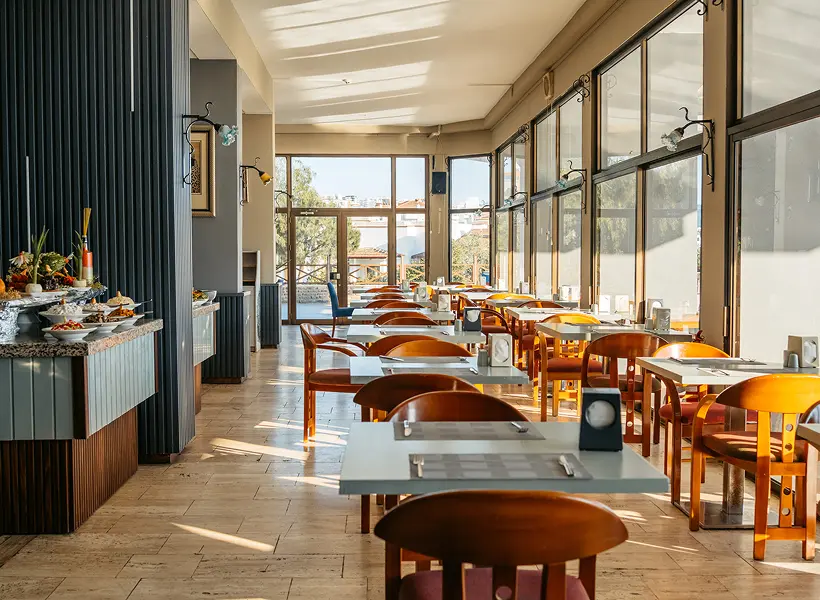Sunlit dining area with large windows.