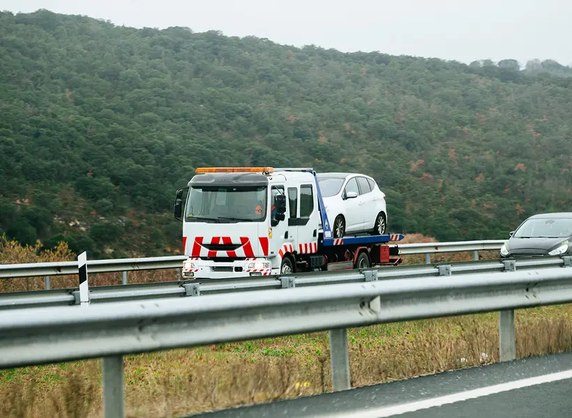 Roadside assistance towing white vehicle