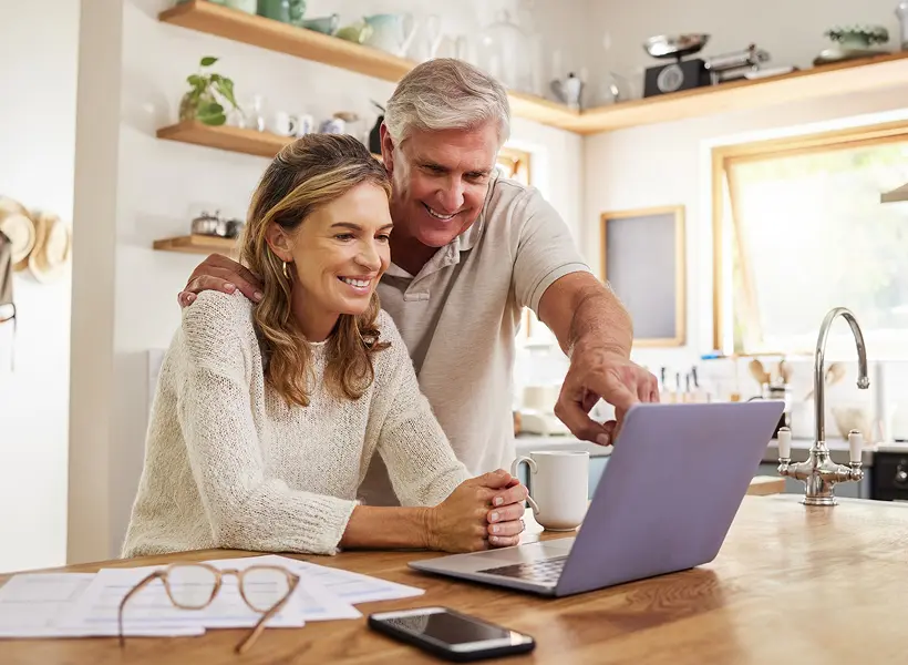 Man and woman using computer at home
