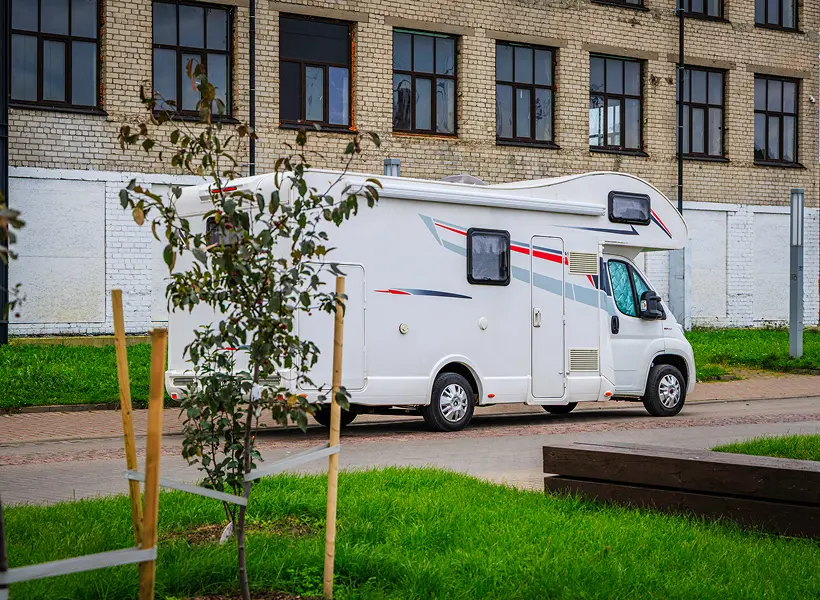 Motorhome beside grassy area