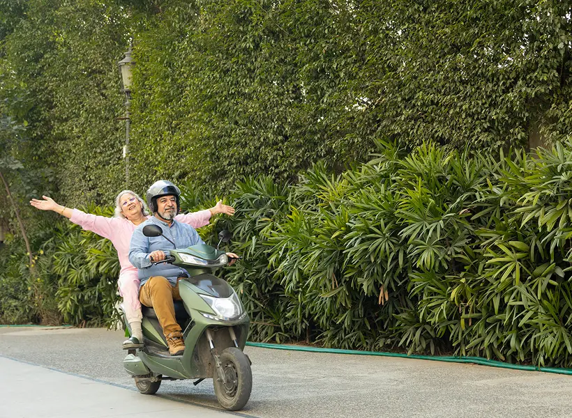 Happy seniors on a scooter ride