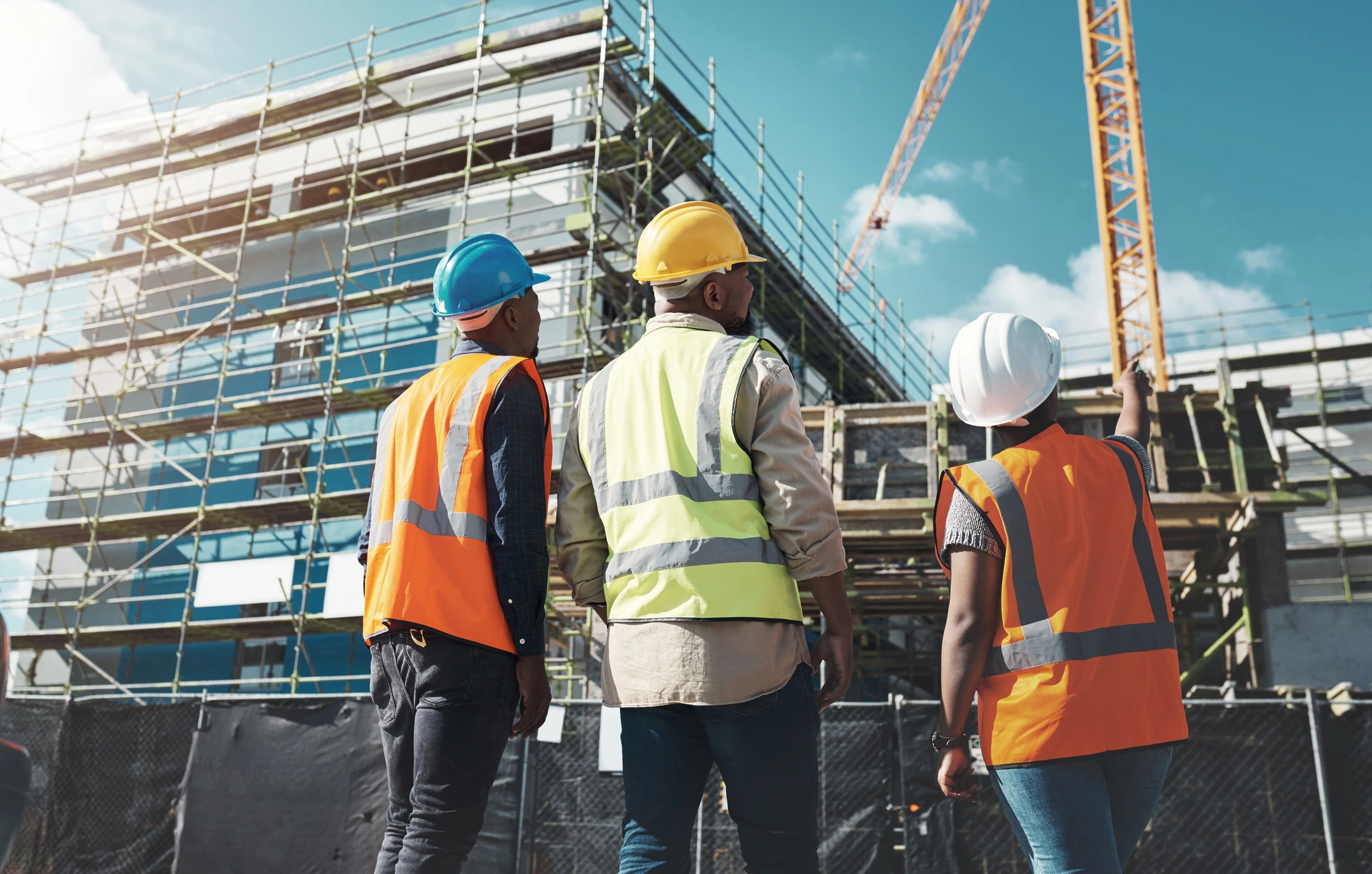 Construction workers observing building site progress